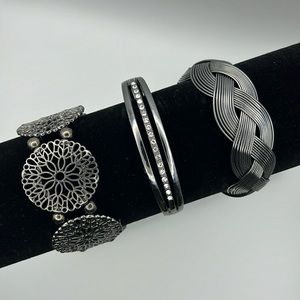 One lot of three ‘gunmetal’ bracelets. One stretch, two cuff. Paparazzi